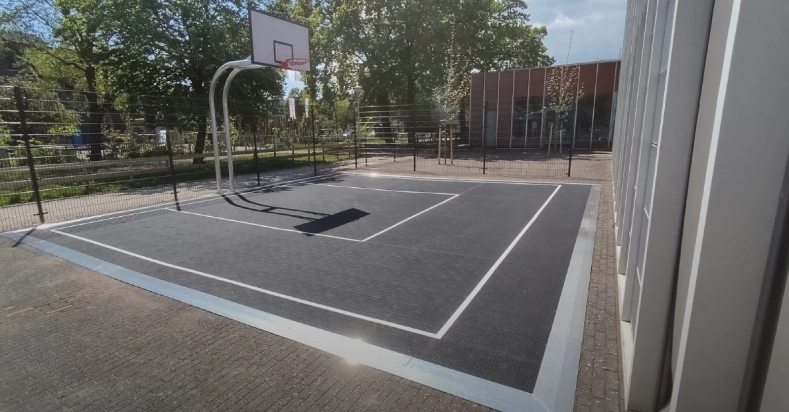 Altra College sets up schoolyard with basketball court